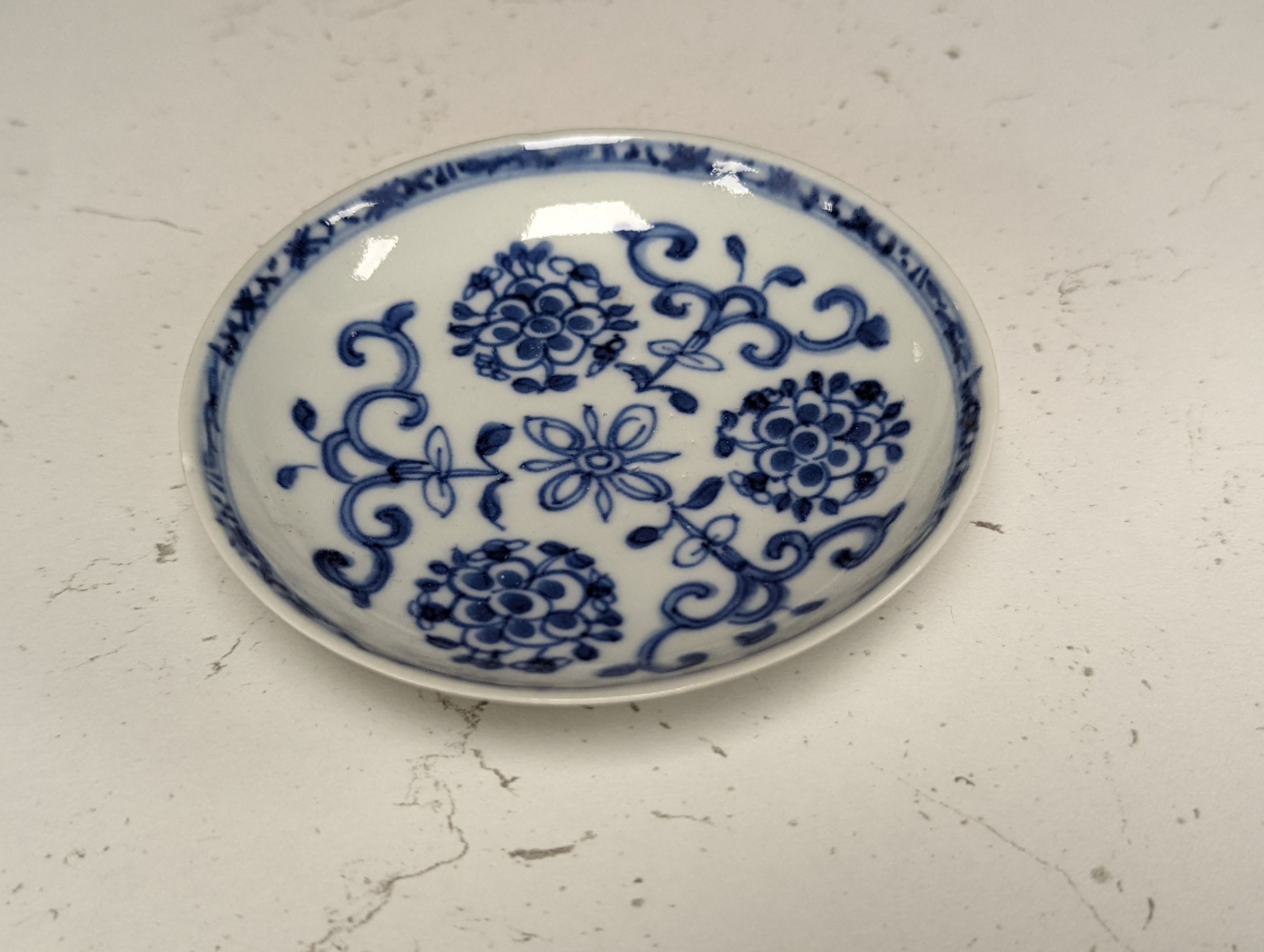 Seven 18th century Chinese saucer dishes, largest 14 cms diameter.